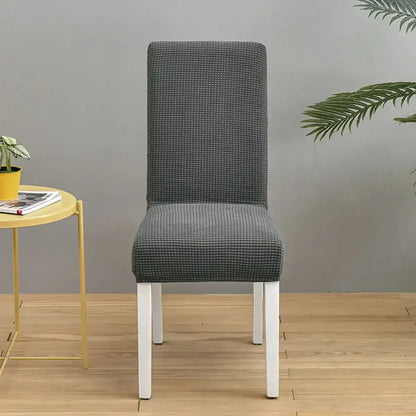 Gray textured chair cover with subtle checkered pattern snugly fitted over a modern dining chair decorbites blue quilted chair cover
