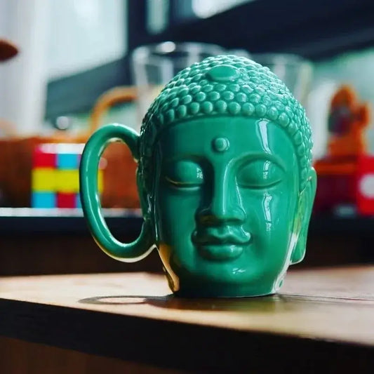 Teal buddha sculpture ceramic coffee mug with detailed facial features and curved handle by decorbites for kitchen decor