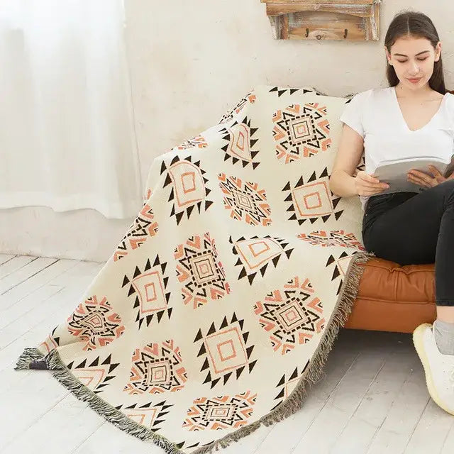 Beige sofa blanket with terracotta and black butterfly carp pattern and fringed edge for living room use