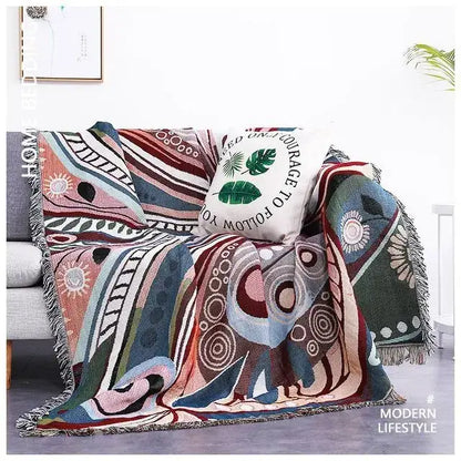 A colorful sofa blanket with dustproof butterfly carp pattern and fringe edges in pink, blue, green, and beige tones