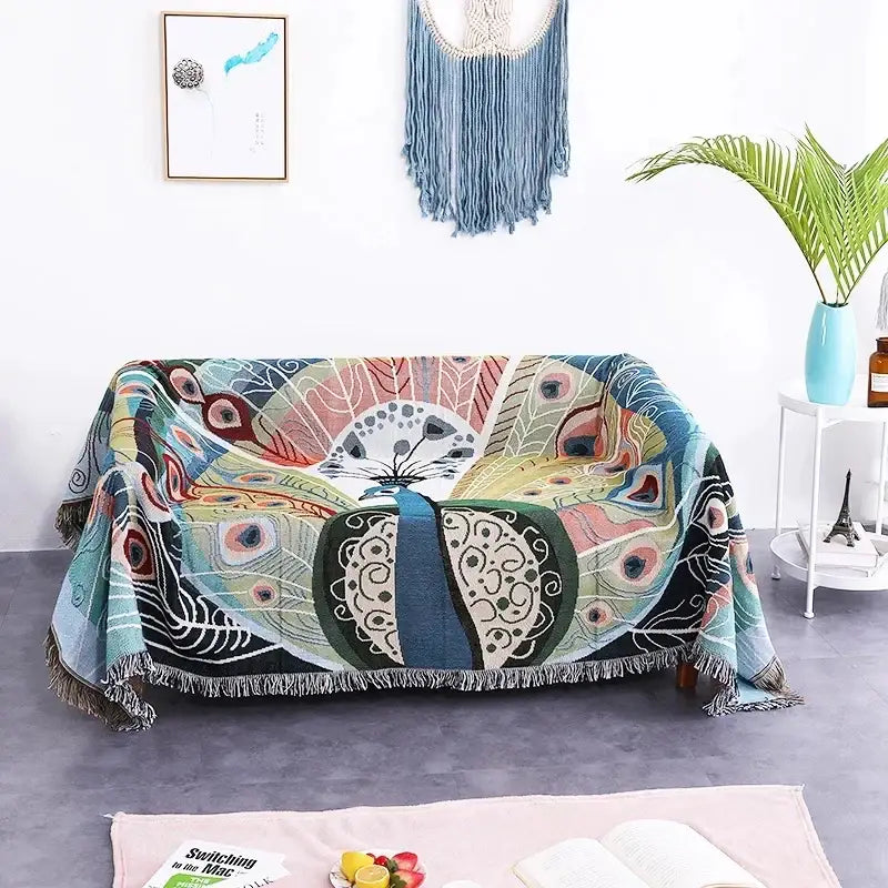 A vibrant teal sofa blanket with butterfly carp pattern and dustproof design draped over a living room sofa