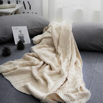 Cream-colored knitted throw blanket with textured woven pattern from decorbites cozy jacquard living room throw collection