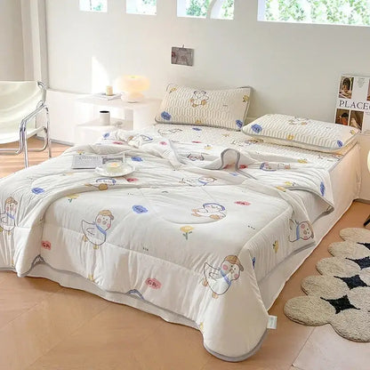 White quilted comforter with cartoon duck and flower patterns in pastel colors soft cotton texture decorbites cool summer blanket set