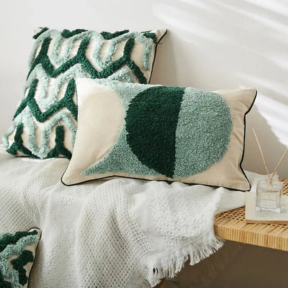 Cream-colored cushion case with plush green geometric embroidery tassel and black piping for living room decorbites decor