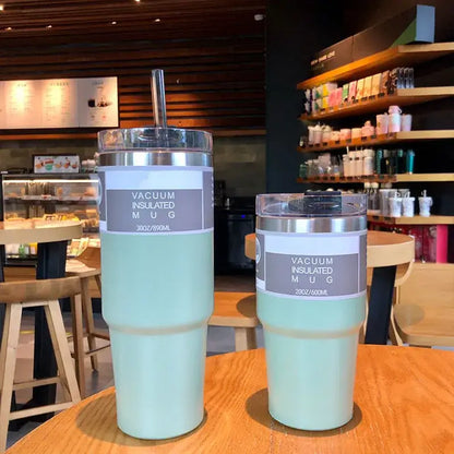 Two mint green decorbites coffee cup thermos mugs with silver lids and clear straws 30oz and 20oz capacity