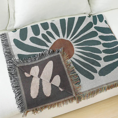 Cozy throw blanket with decorbites daisy pattern woven design in teal and tan featuring fringed edges for living room decor