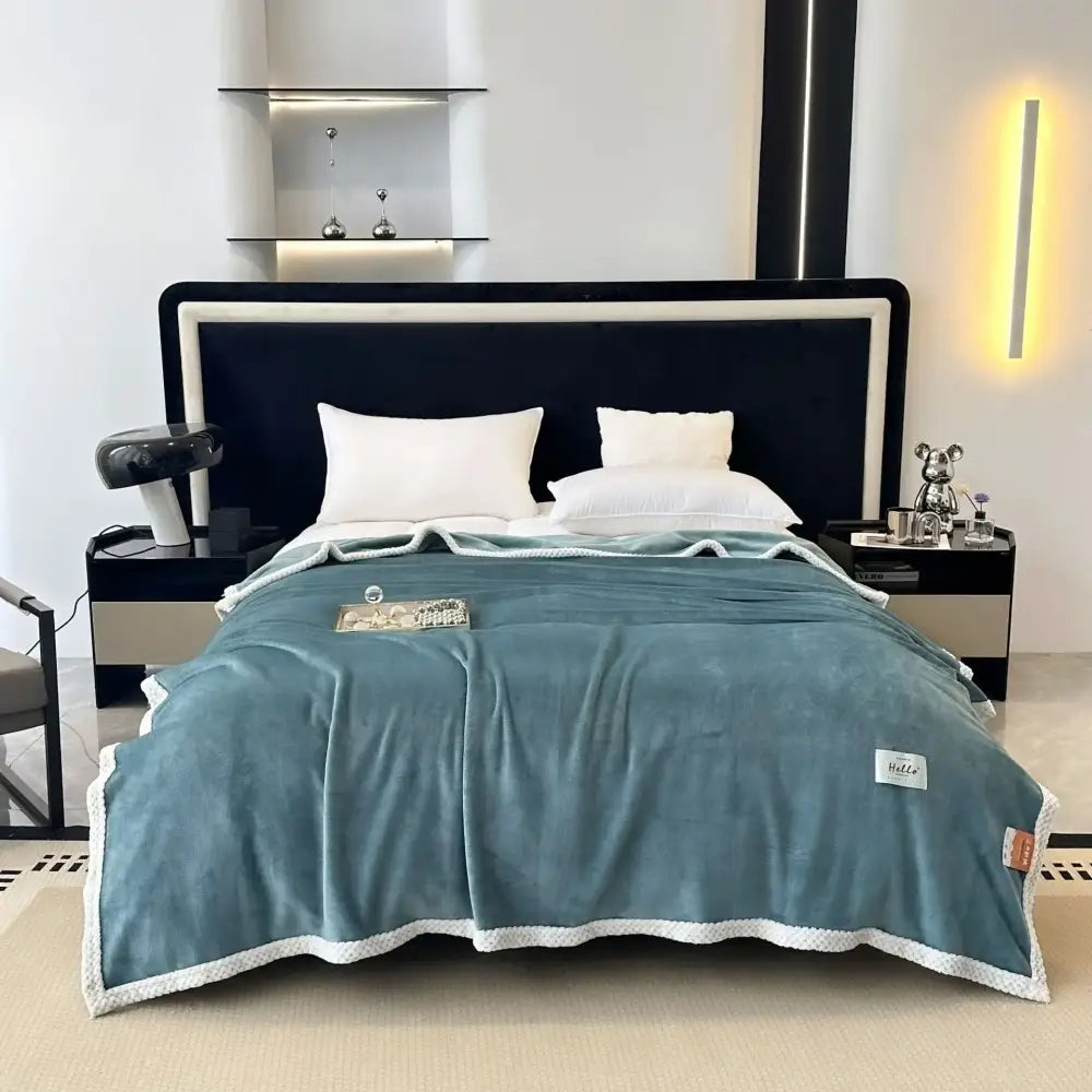 Teal and white cozy flannel nap blanket with plush throw texture and subtle brand tags for bedroom use
