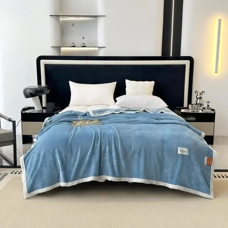 Teal and white cozy flannel nap blanket featuring a soft light blue plush throw with a white textured border and stitching details