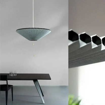 A modern light blue pleated decorbites deformed fabric umbrella pendant lamp with black rim and white cord for dining room