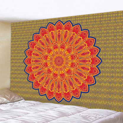Vibrant orange and red indian mandala psychedelic tapestry with bold blue outline hanging on gold-patterned wall decorbites decor