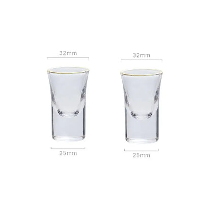 Clear glass shot glasses with gold rim and etched details complementing the teardrop glass wine pot for dining room and bar