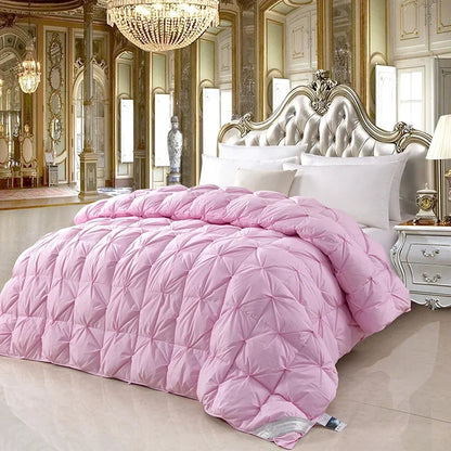 Pink quilted comforter with diamond-stitched design featuring temperature controlled white goose down for warmth and comfort