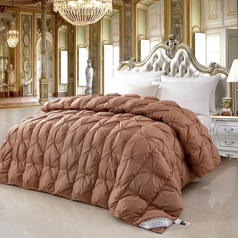 A rust-colored temperature controlled down quilt with thickened core filled with white goose down for warmth and comfort
