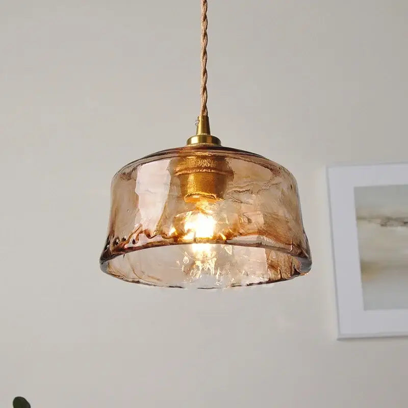 A warm amber glass pendant light with textured hand-blown finish and brass hardware for dining room decorbites amber glass
