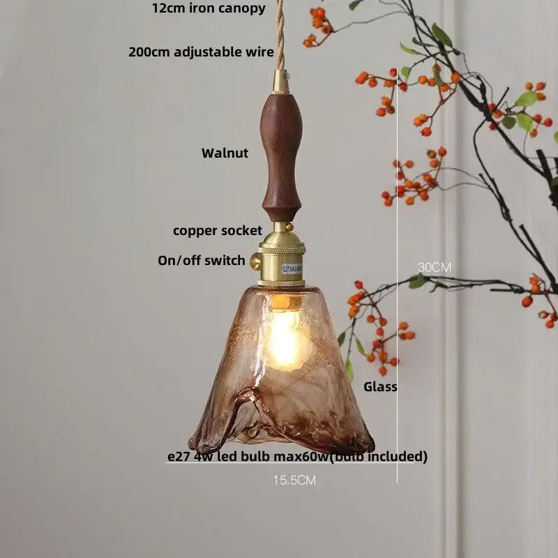 Warm amber glass pendant light with walnut handle and brass accents designed for dining room decorbites amber glass