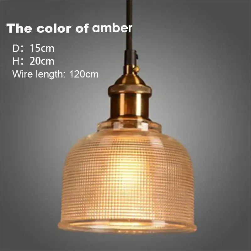 Amber-colored textured ribbed glass pendant lights with brass-finished hardware for dining room use