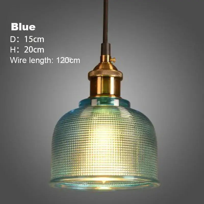 Blue glass pendant light with textured ribbed surface and brass metal fixture in dining room glass pendant lights set