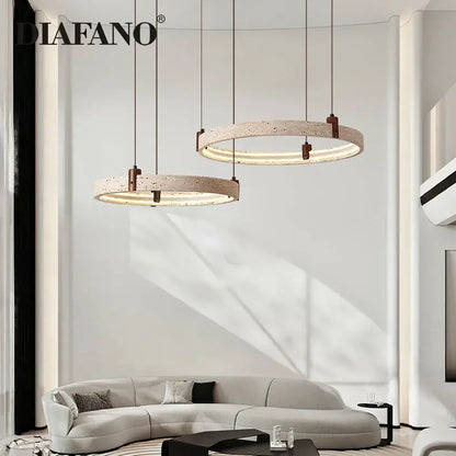 Modern circular pendant light with textured beige concrete finish and warm LED illumination decorbites cave stone chandelier