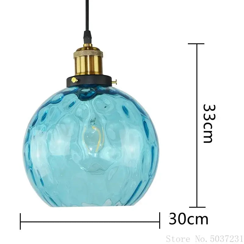 Textured blue glass ball pendant light with translucent bubble surface and brass socket for dining room decorbites blue glass