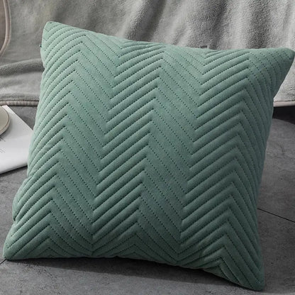 A soft sage green quilted cushion cover with textured chevron pattern ideal for decorbites blue wave living room decor