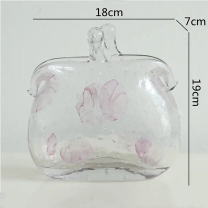 Textured clear glass vase with pink floral patterns and leather handles for living room decorbites clear glass use