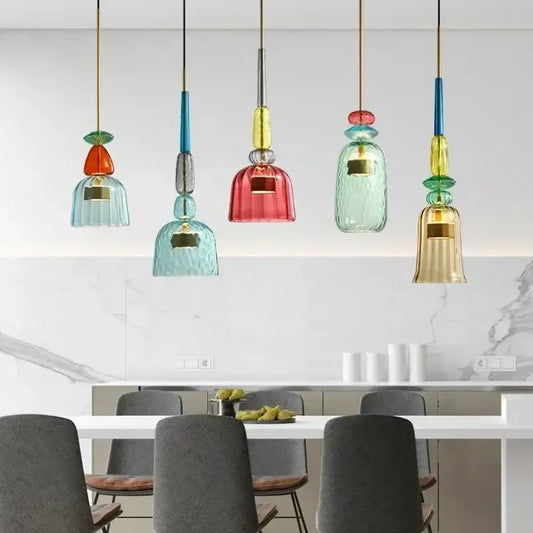 Colorful glass pendant lights with textured bell-shaped shades in teal red and gold for kitchen dining chandelier