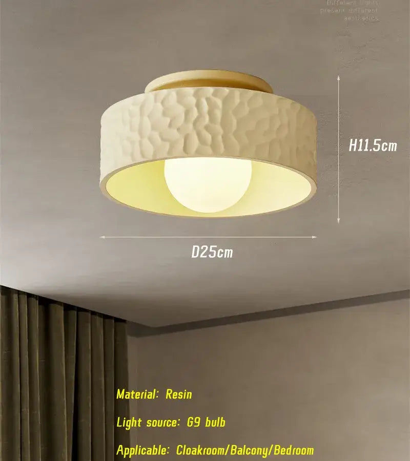 Cream ceiling light with textured hammered resin finish and gold trim emitting warm glow from 69 watt bulb for living room decorbites cream ceiling