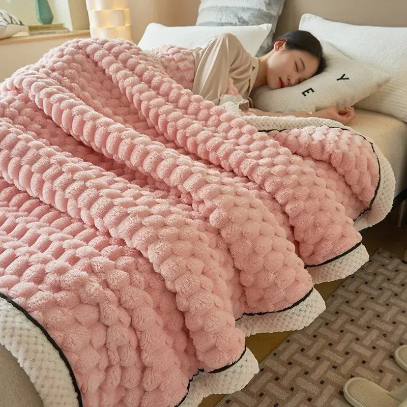Pink chunky knit throw blanket with plush coral fleece textured surface and contrasting white trim for warm blanket use