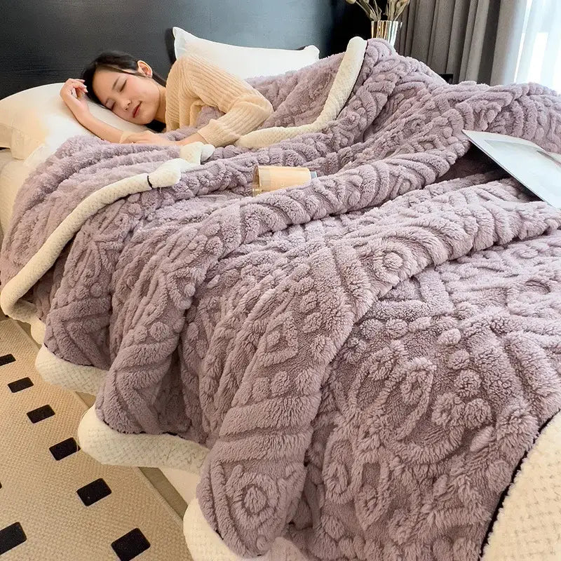 A plush lavender coral fleece warm blanket with textured pattern cream lining and black trim by decorbites