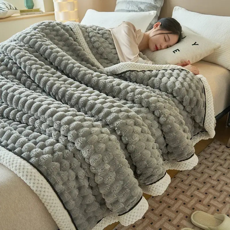Gray coral fleece warm blanket with textured raised pom-pom pattern and cream-colored border trim by decorbites