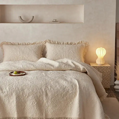 Cream-colored decorbites cotton quilted bedspread set with textured leaf pattern and soft frayed edges for bedroom decor