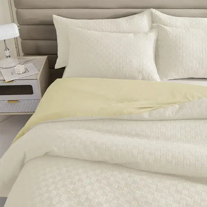 Cream-colored quilt set with subtle woven texture and matching pillowcase quilt set from DecorBites comforter collection