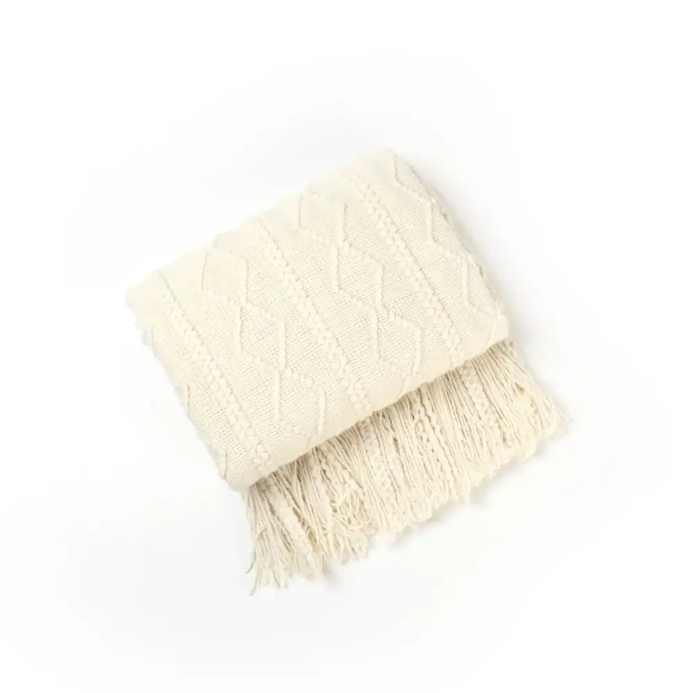 Cream-colored textured diamond cozy knit throw blanket with fringe perfect for living room decorbites cozy knit