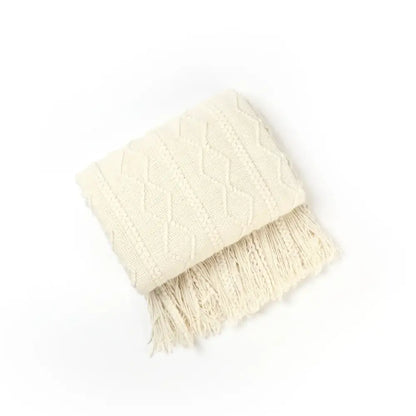Cream-colored textured diamond cozy knit throw blanket with fringe perfect for living room decorbites cozy knit