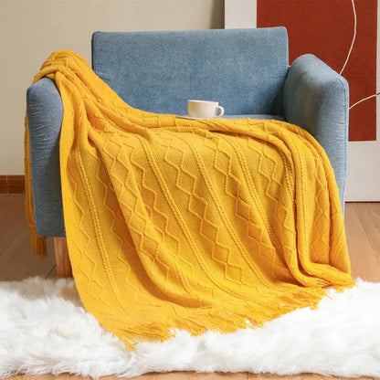 Vibrant yellow knit throw blanket with diamond cable pattern and fringed edges perfect for decorbites cozy knit decor