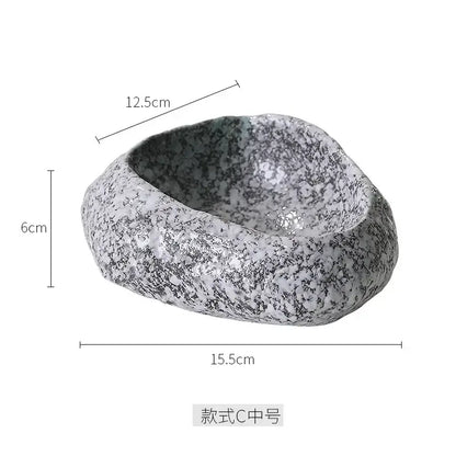A gray and white speckled decorbites ceramic dessert bowl with a rough natural stone texture for dessert sashimi ice
