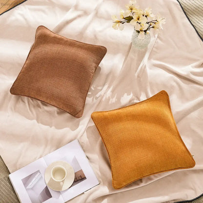 Two square textured cotton linen pillow covers in warm brown and mustard yellow tones for living room decorbites cushion cover set