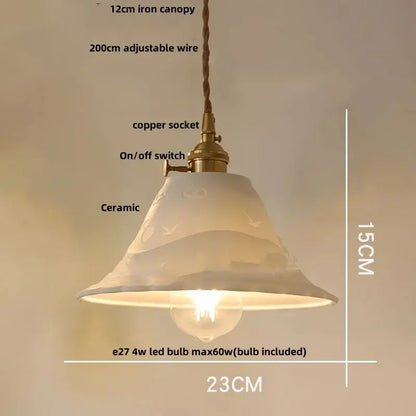 A delicate off-white ceramic pendant light with subtle bird motifs and brass copper socket for decorbites clear glass decor