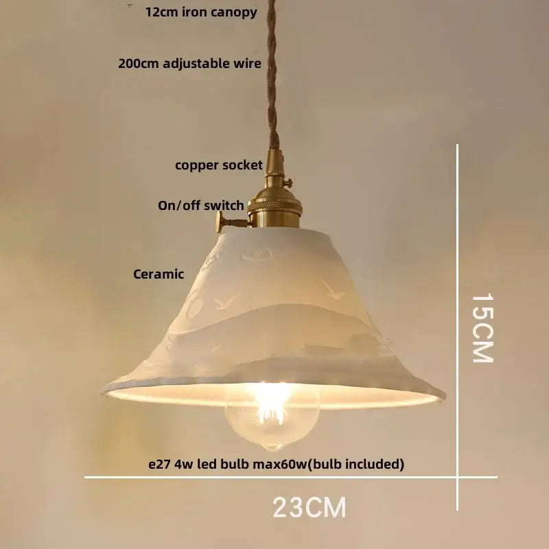 A delicate off-white ceramic pendant light with subtle bird motifs and brass copper socket for decorbites clear glass decor