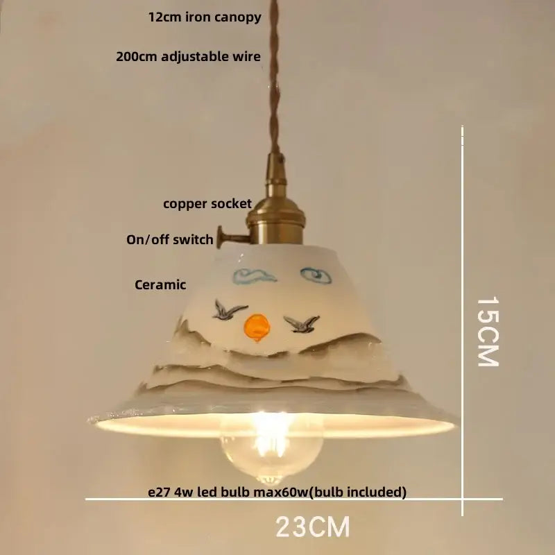 A ceramic pendant light with hand-painted face design and soft white glaze for decorbites clear glass led lighting