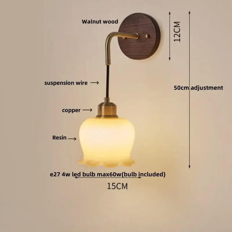 A warm amber-lit textured glass and wood decorbites adjustable led wall light with walnut and copper accents