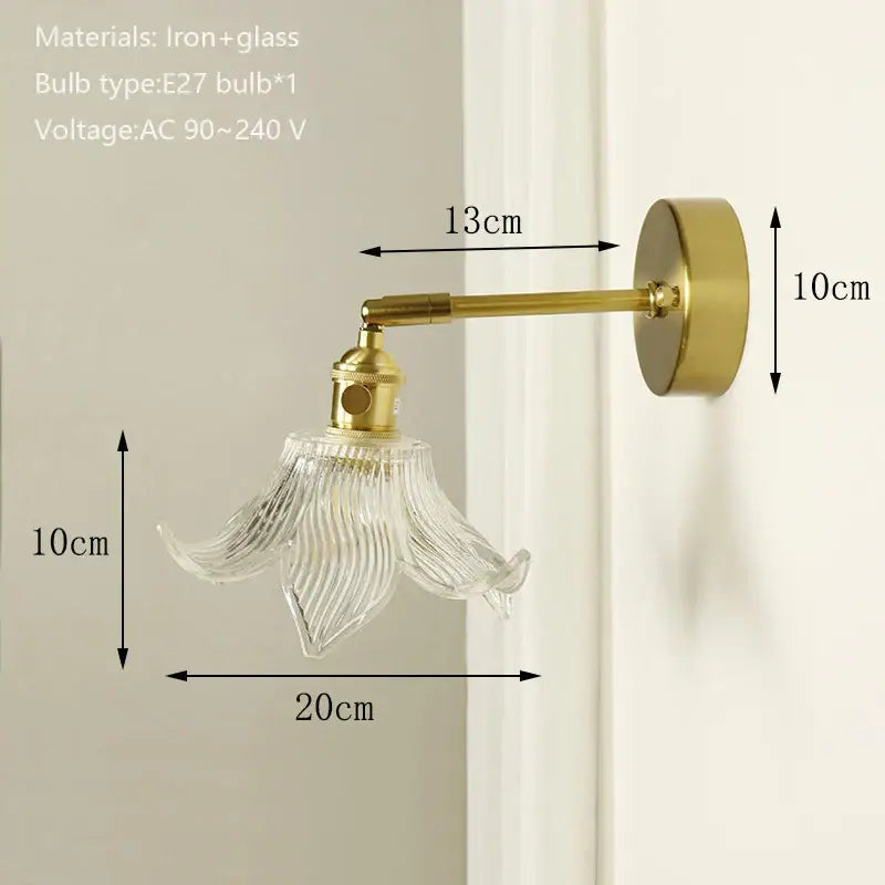 Delicate gold-toned wall sconce with clear ribbed glass shade and brass mirror for bedroom decorbites brass mirror