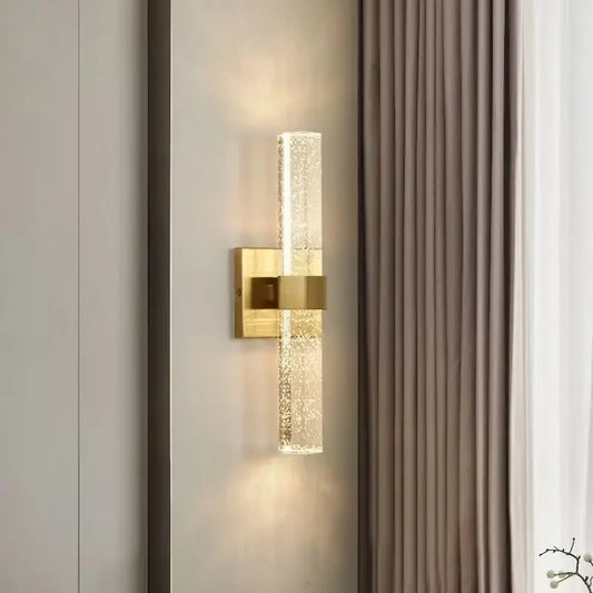 Gold wall sconce with textured translucent glass cylinder diffusing warm light for bedroom decorbites gold wall sconce