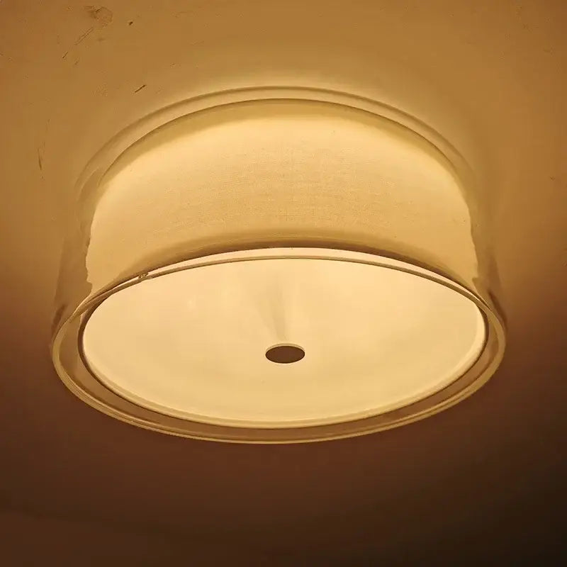 Warm-toned ceiling light with textured gold rim and pleated white glass shade ideal as a bedroom ceiling lamp