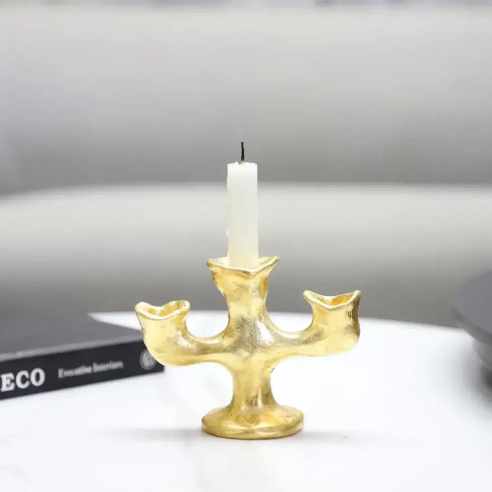 Gold resin candle holder with textured surface and white pillar candle decorbites gold resin dining room centerpiece