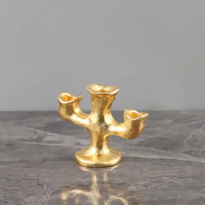 Gold resin candle holders trio featuring textured three-arm design in sculpted organic decorbites gold resin centerpiece