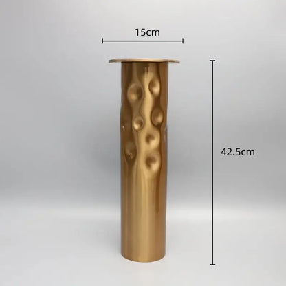 A tall cylindrical brass golden metal candlestick holder with hammered texture for decorbites dining room decor