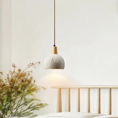 Minimalist pendant lamp with textured light gray cement shade and natural wood accent for dining room decorbites cement chandelier