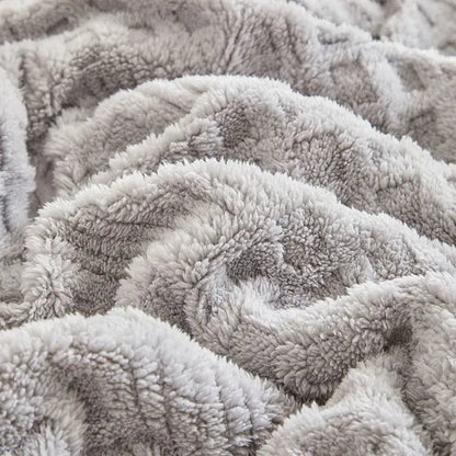 A plush soft gray coral fleece blanket with a cozy textured surface ideal for bedroom knit throw use