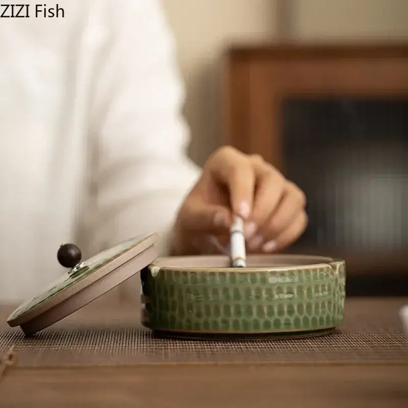 Textured green ceramic ashtray with reptile-skin pattern and wooden lid with dark knob by decorbites ceramic ashtray